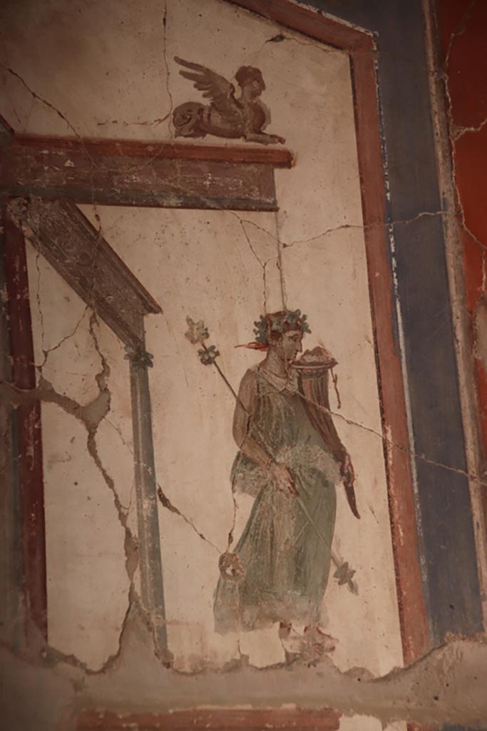 VI.16 Herculaneum. October 2022.
Detail of painted maenad holding a cornucopia, from upper north end of east wall.
Photo courtesy of Klaus Heese.